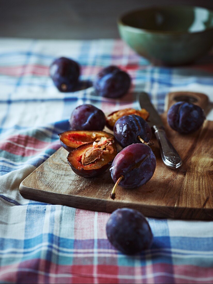 ripe plums on a wooden kitchen board