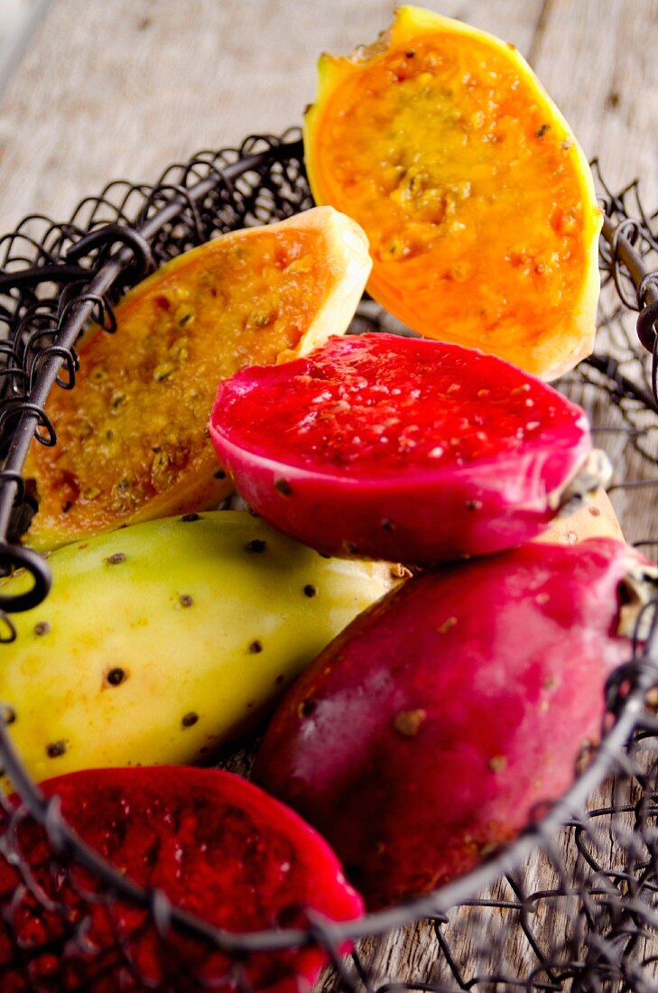 Prickly pears in various colours in a wire basket