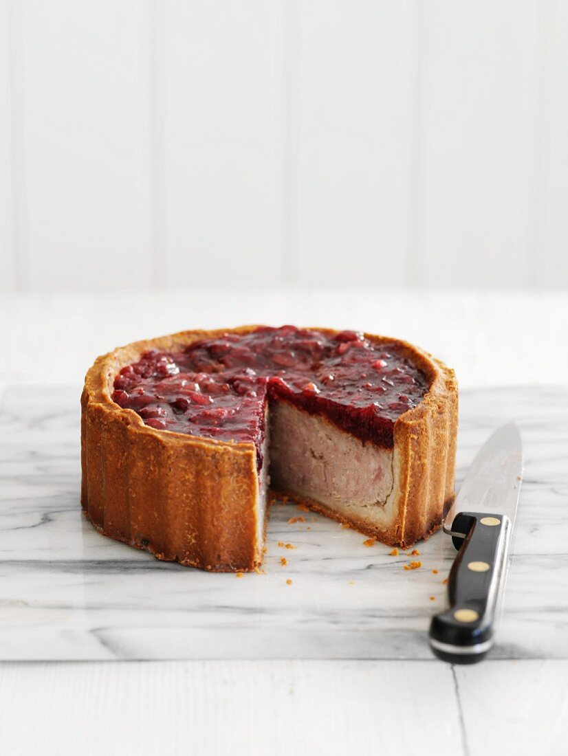Pork pie with cranberries, sliced