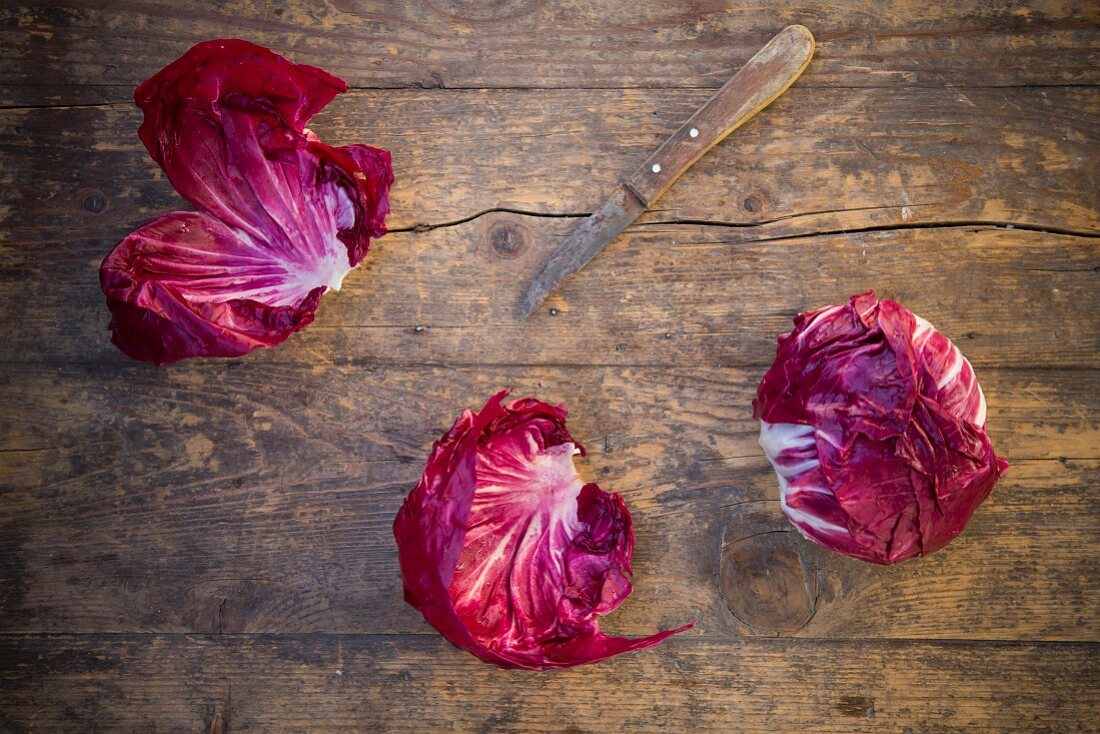 Radicchio with a knife on a wooden table