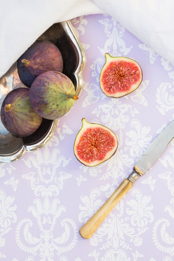 Figs in and next to a silver bowl