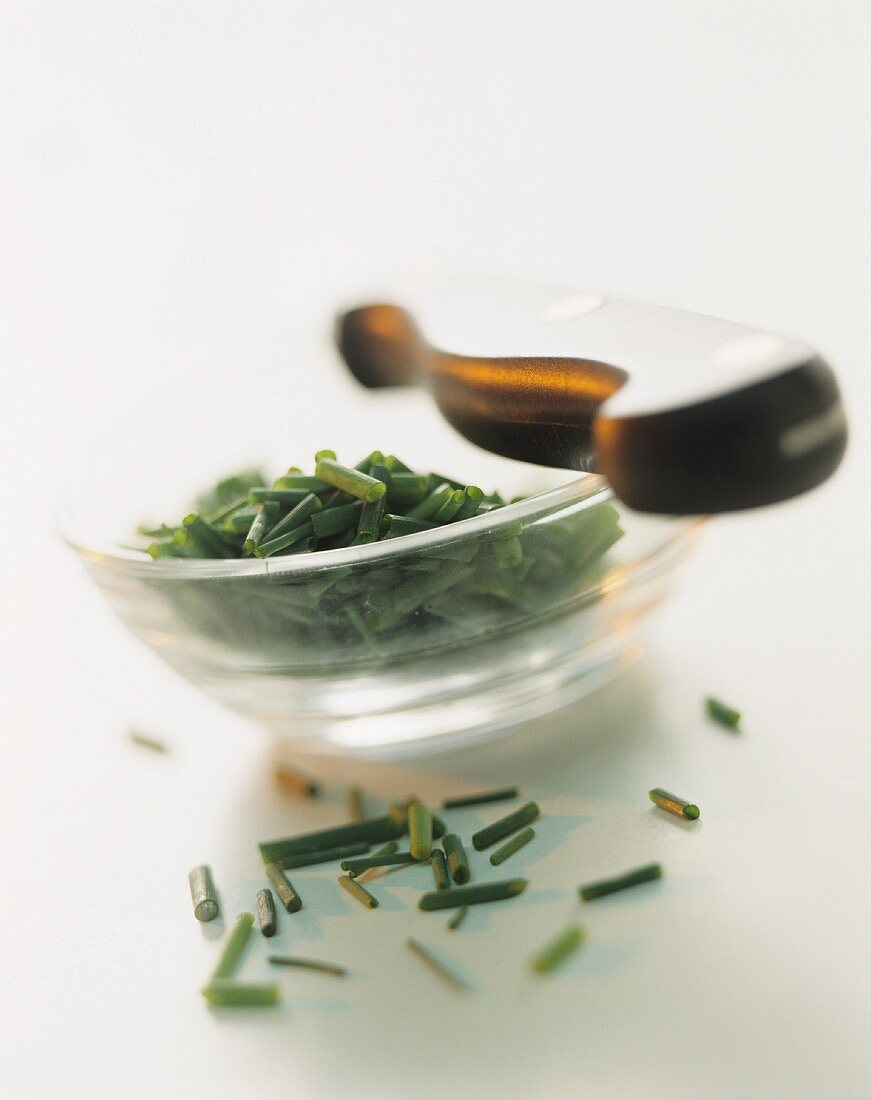 Finely chopped chives in a small glass bowl