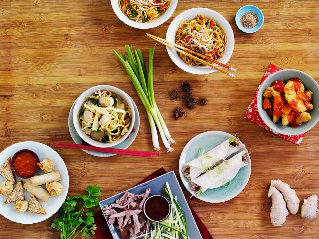Assorted Chinese dishes on a wooden table