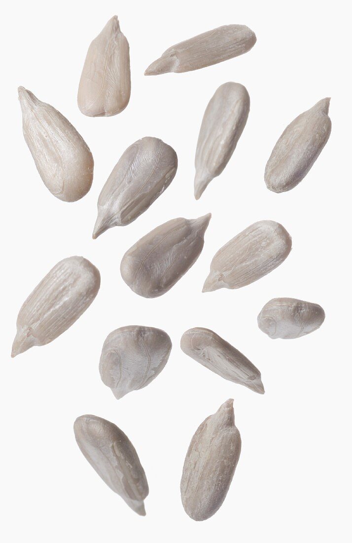 Sunflower seeds in front of white background