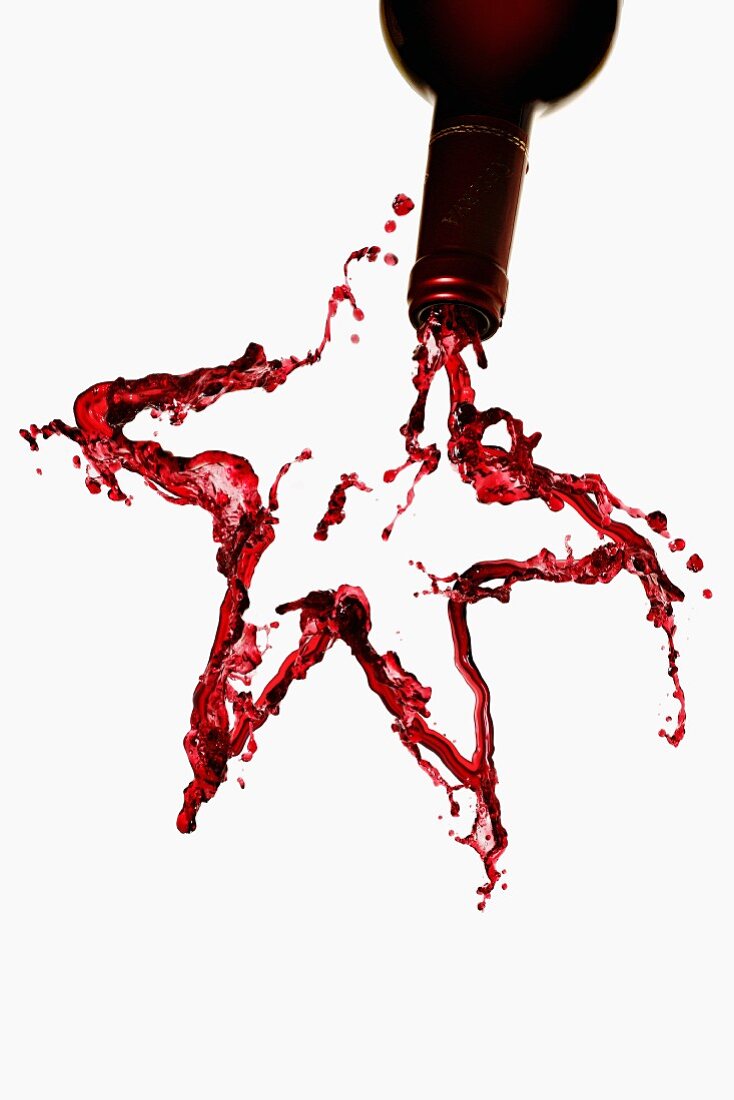 A star made from red wine, against a white background