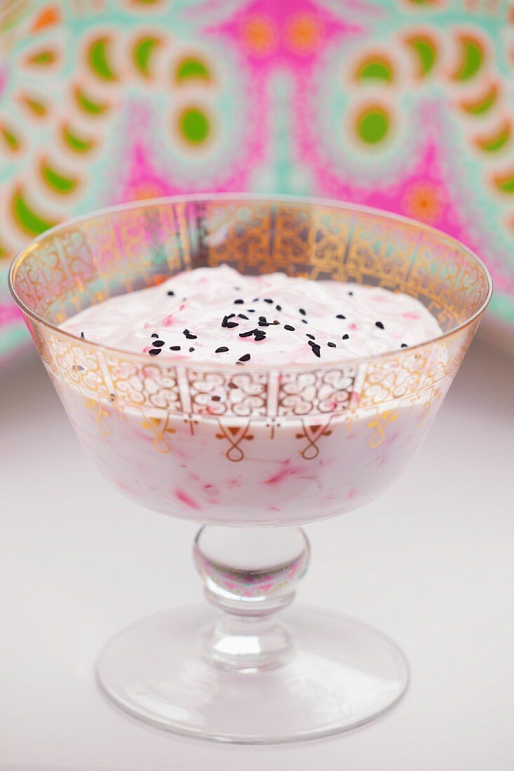 Lime yogurt with raspberries and black sesame seeds