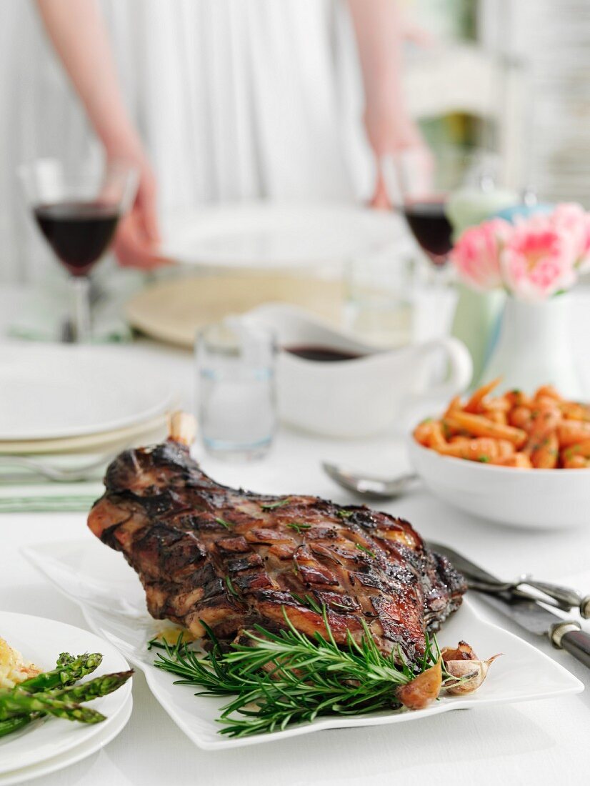 A table laid for a meal, with a roast leg of lamb