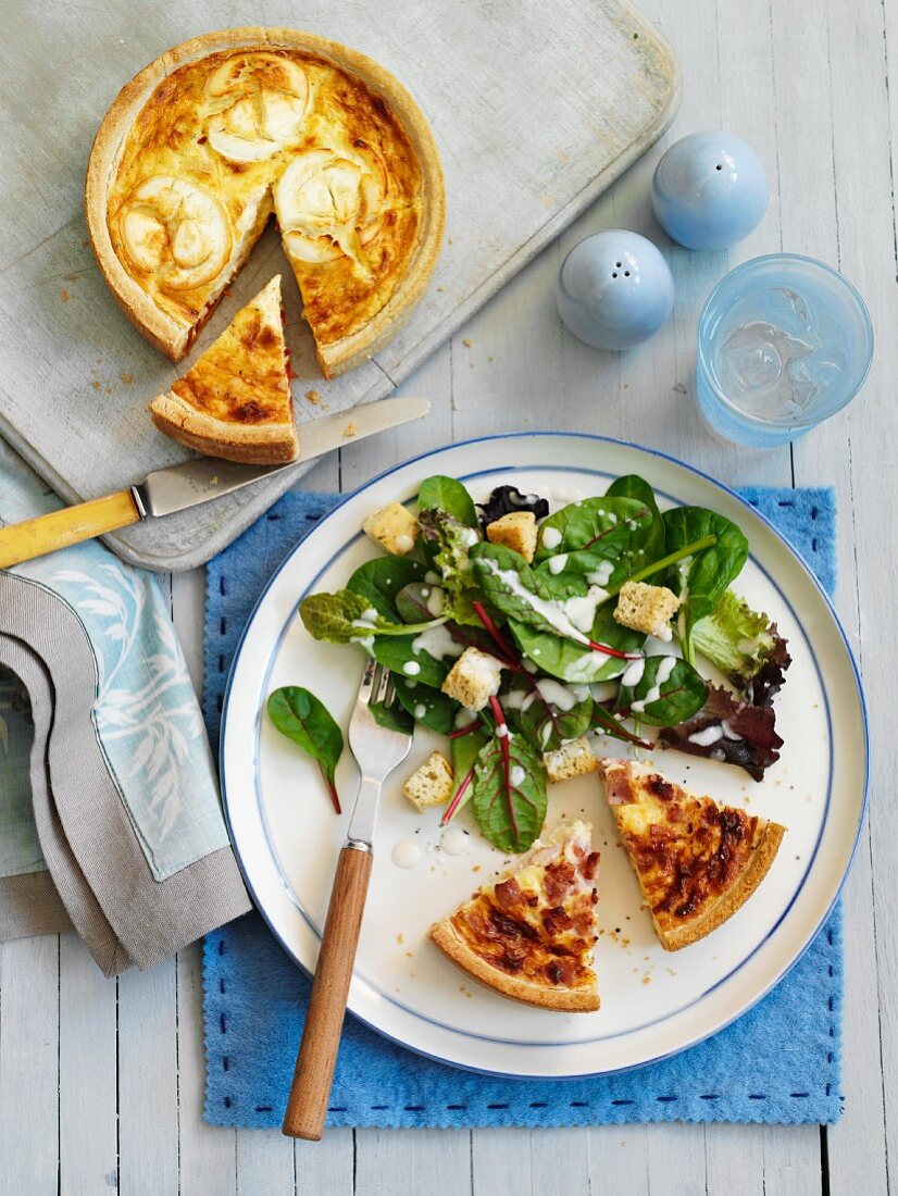 Quiche with green salad and croutons (top view)