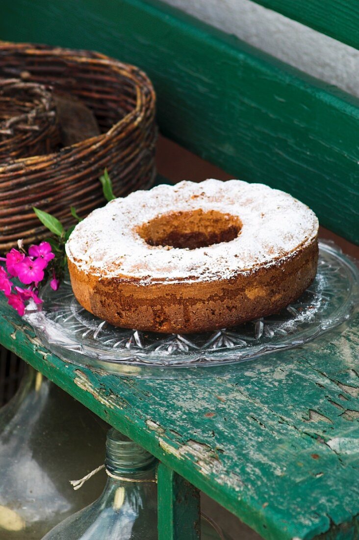 Marble cake with icing sugar on a rustic wooden bench