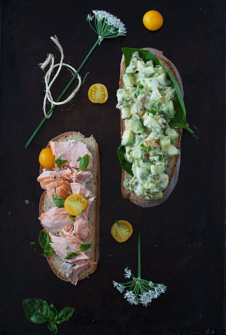 An Open faced Sandwich with Salmon, Avocado, Eggs and Yellow Tomatoes