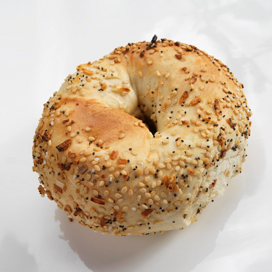 A Single Everything Bagel on a White Background