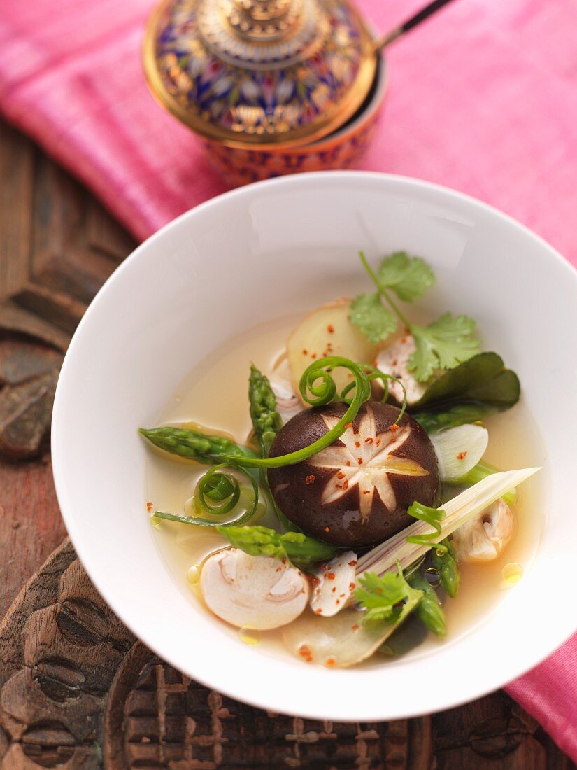 Clear shiitake mushroom soup with green asparagus