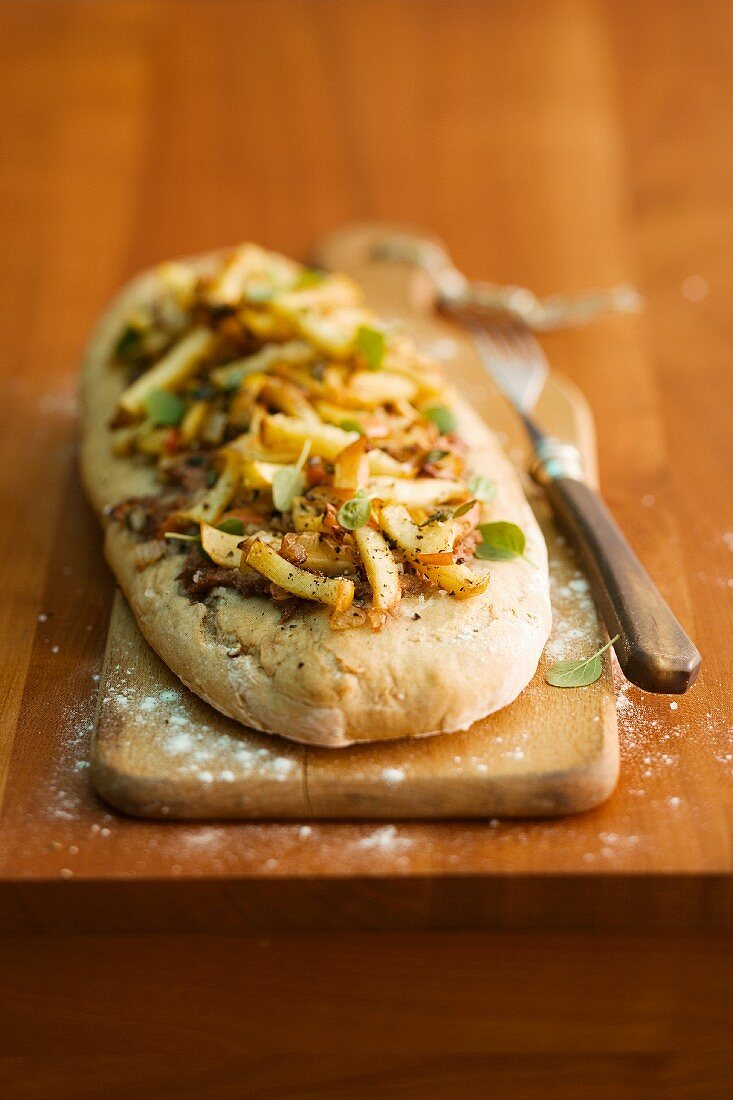 Oblong flatbread topped with apple and liver sausage