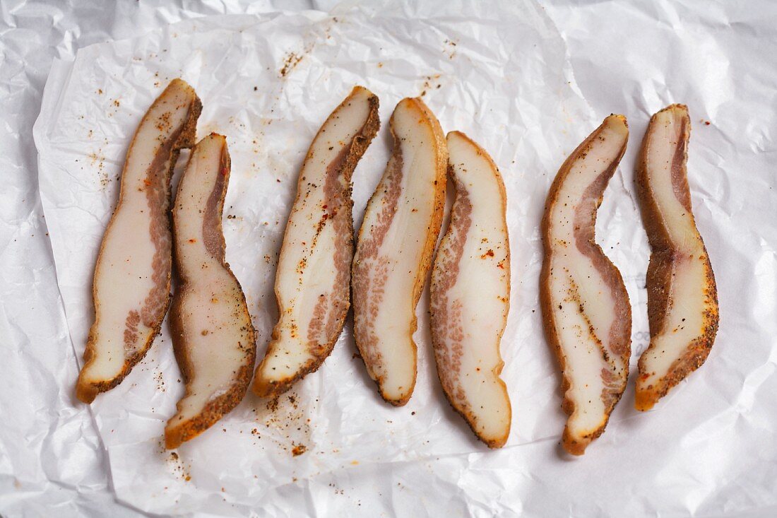 Slices of Guanciale on butchers paper
