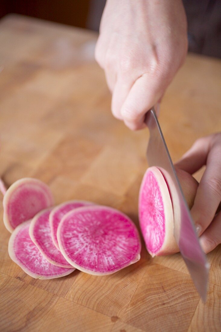 A watermelon radish being sliced
