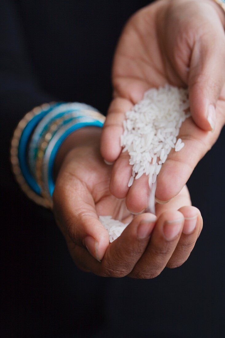 Hands Holding White Rice
