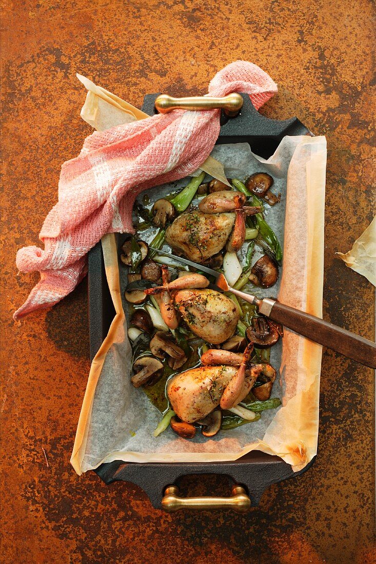 Oven-roasted quails with mushrooms and vegetables