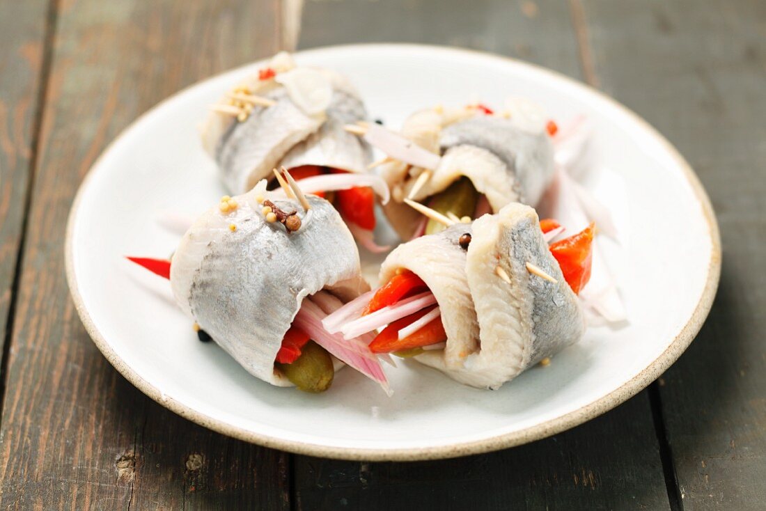 Rollmops filled with pepper strips and pickled gherkins