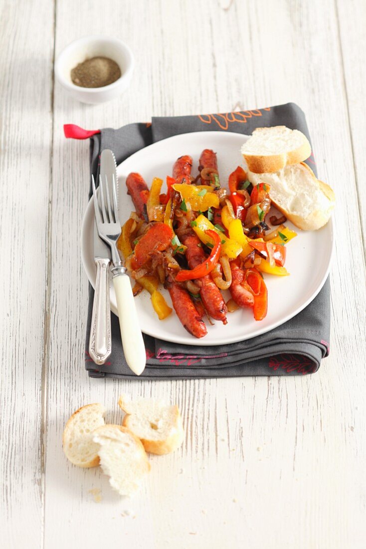 Mini sausages with peppers and onions