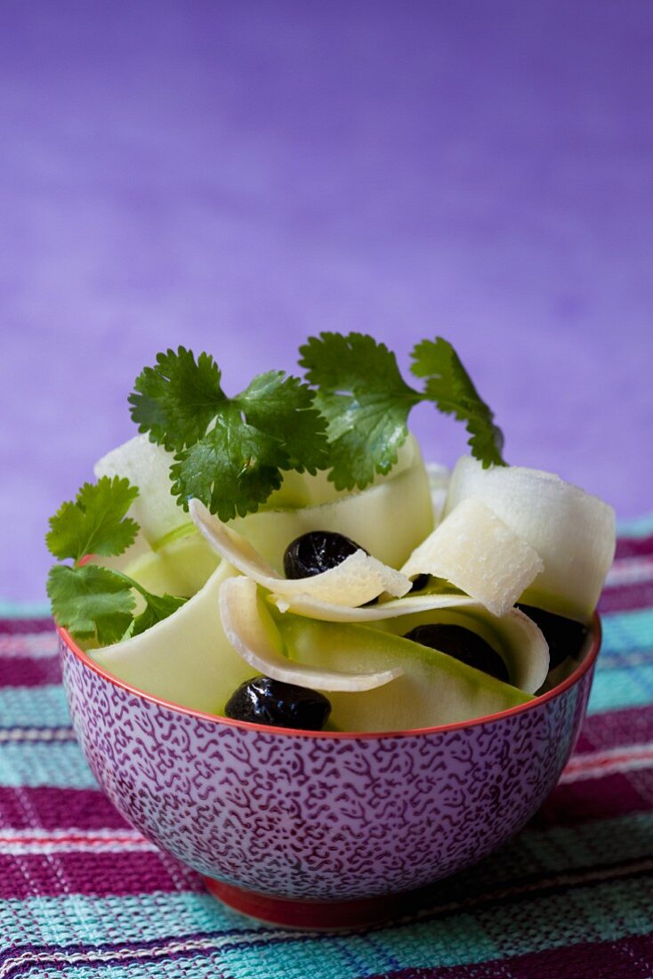 Courgette salad with parmesan shavings, olives and coriander leaves