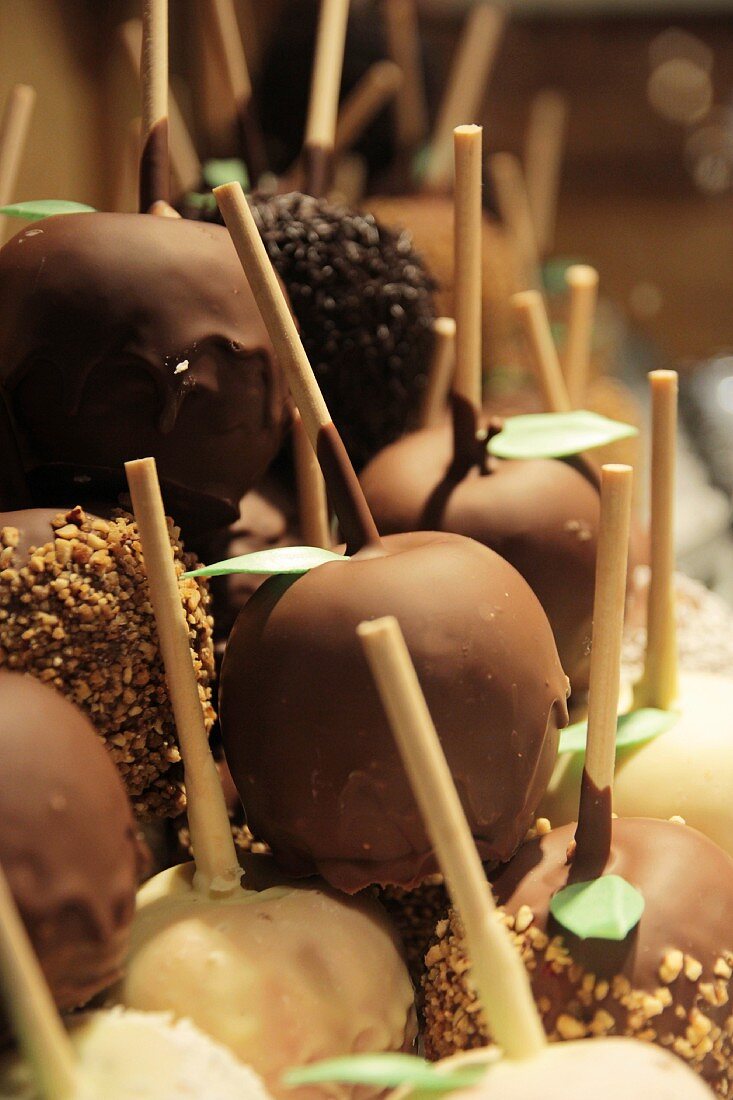 Toffee apples coated with nuts and nut brittle at the Christmas market