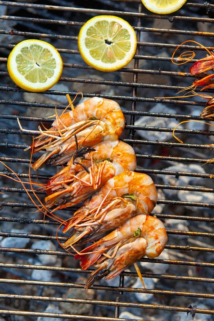 A prawn skewer on a charcoal grill