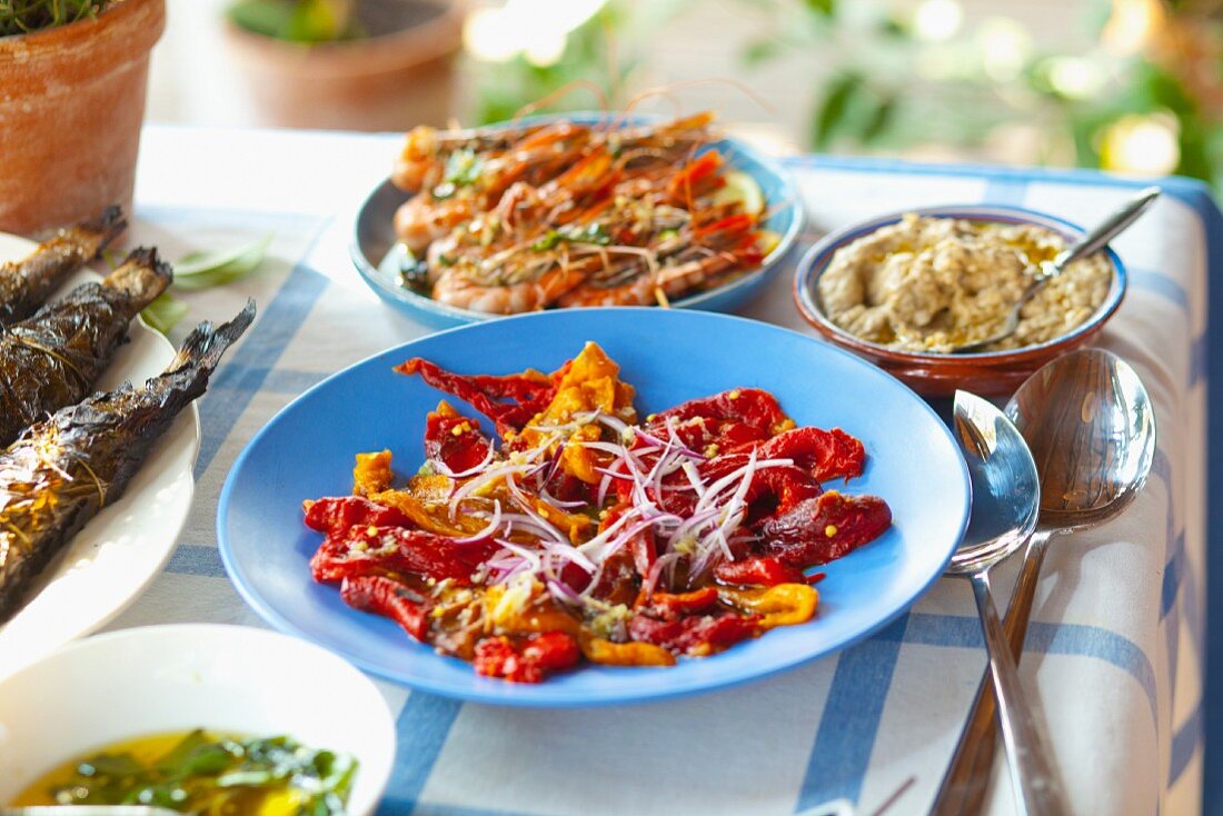 A salad of grilled peppers, prawn skewers and kiopoolu paste