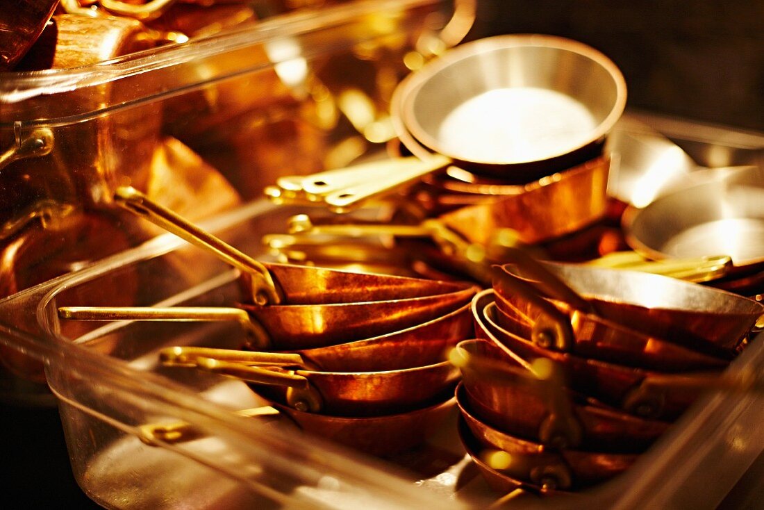 Pans stacked up in a restaurant kitchen