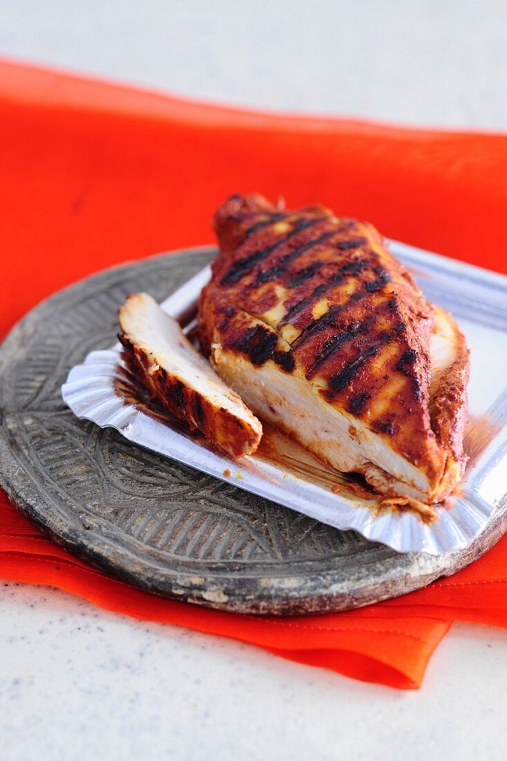 Tandoori chicken breast cooked on the barbecue