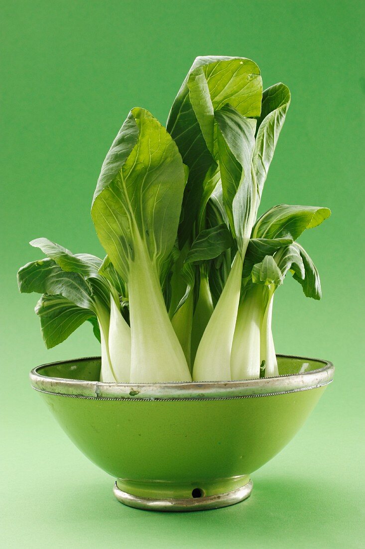 Fresh pak choi in a green bowl