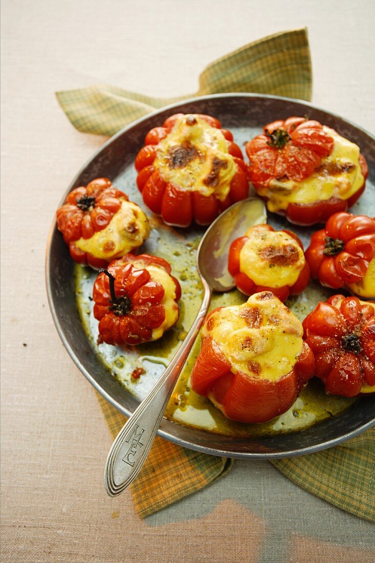 Stuffed tomatoes topped with cheese and baked