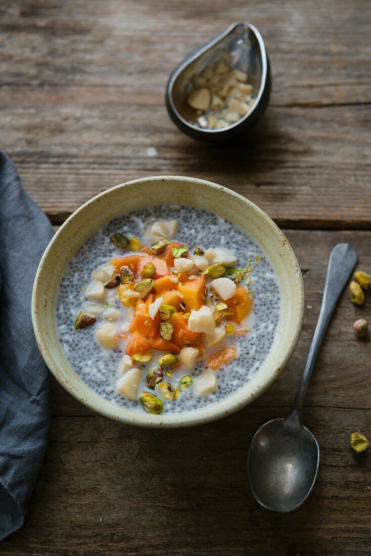 Chia pudding with papaya, macadamia and pistachios