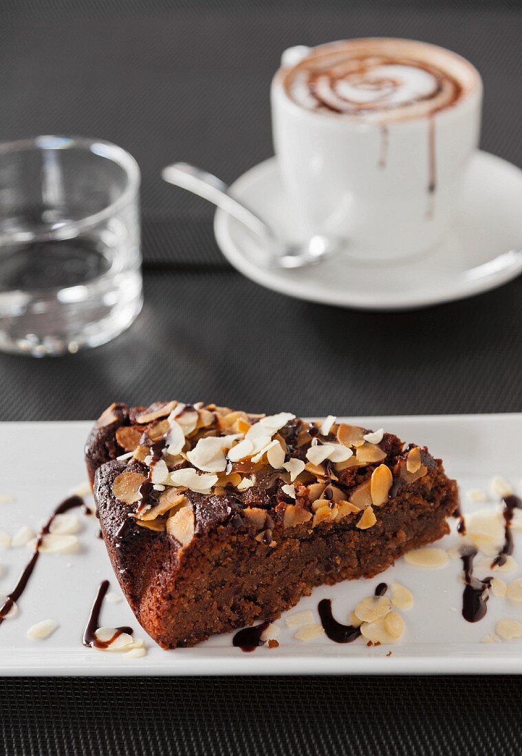 A slice of almond cake and cappuccino