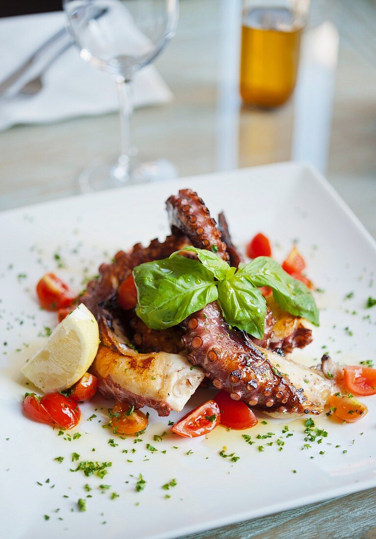 Fried octopus with tomatoes and basil