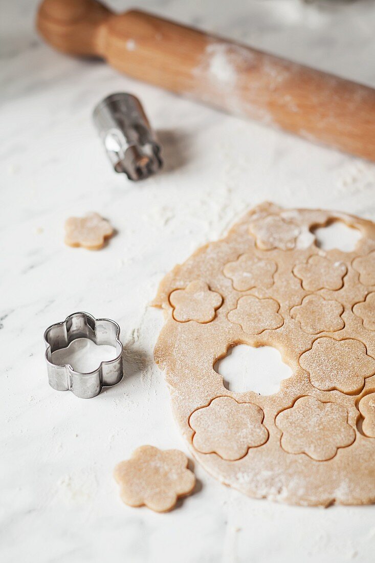 Shapes being cut out of biscuit dough