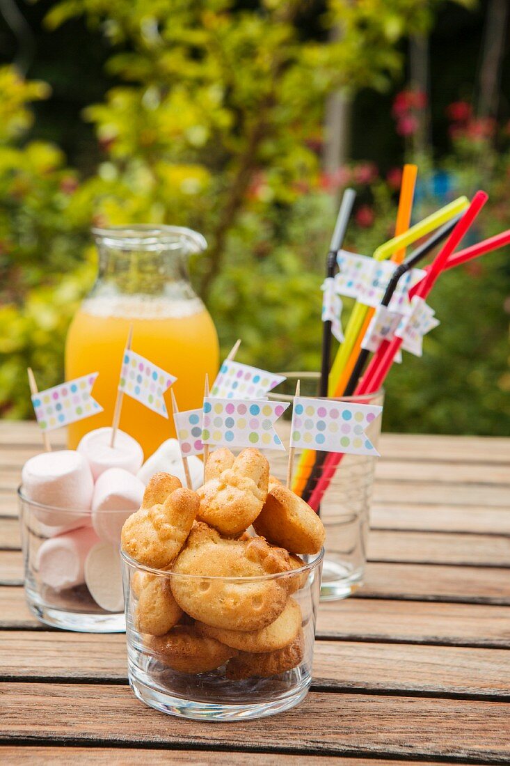 Baked treats, marshmallows and drinking straws decorated with flags for a child's birthday