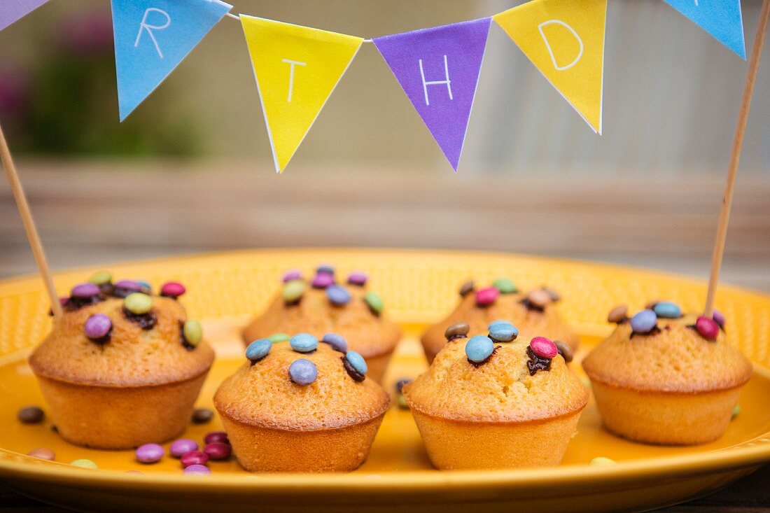 Muffins with chocolate beans and bunting for a child's birthday