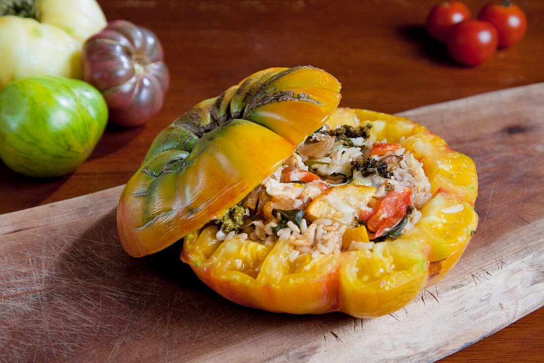A Stuffed Heirloom Tomato with Rice, Yellow Squash, Broccoli, Onion, Basil and Parmesan Cheese