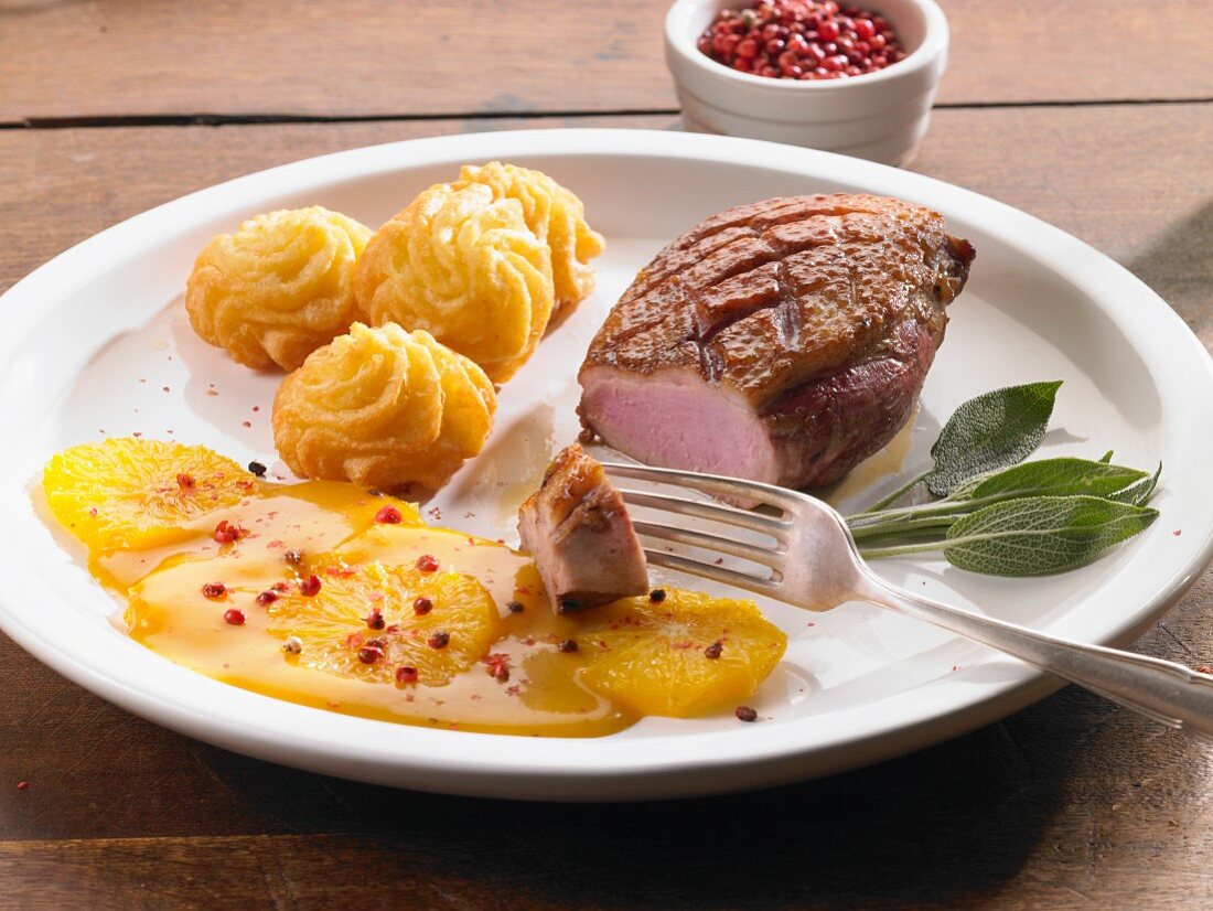 Duck breast with orange sauce and pink peppercorns