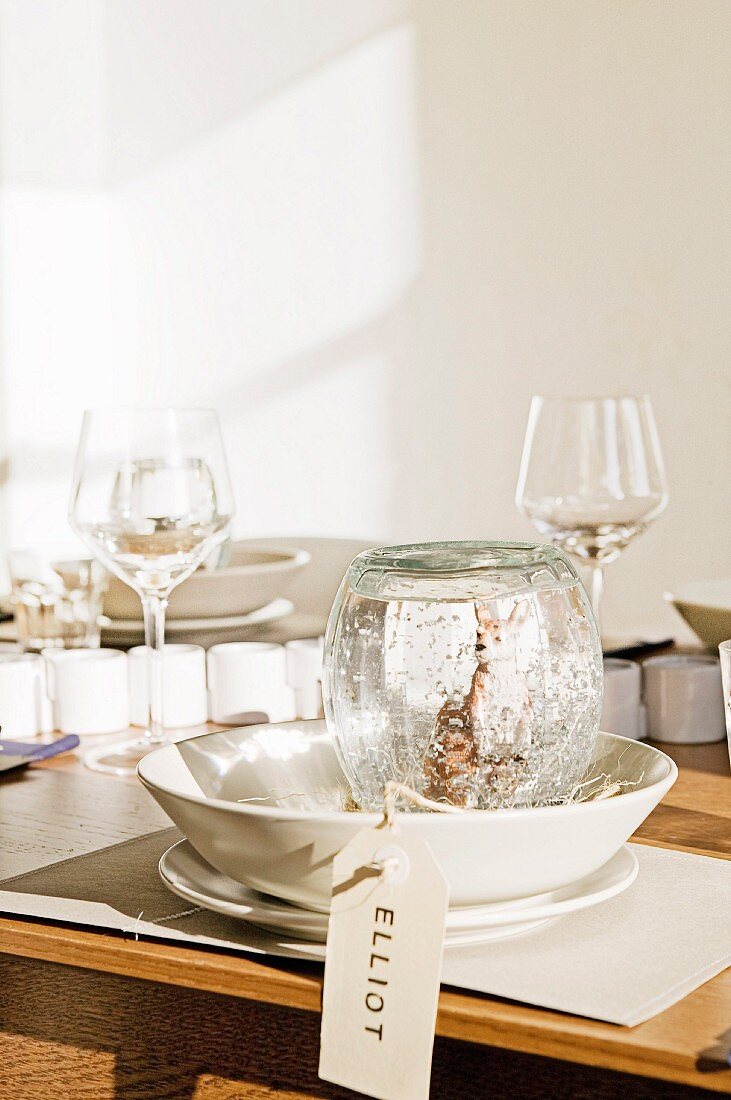 Homemade snow globe on a simply laid table