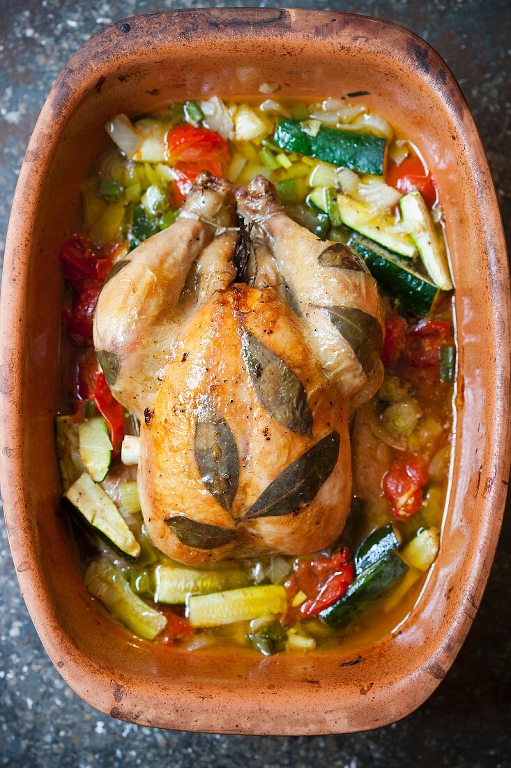 Bay chicken with vegetables in a clay pot