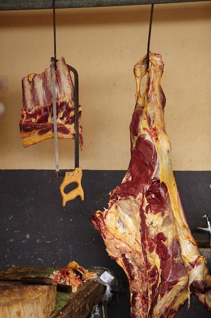 Joints of beef hanging up in a butchers