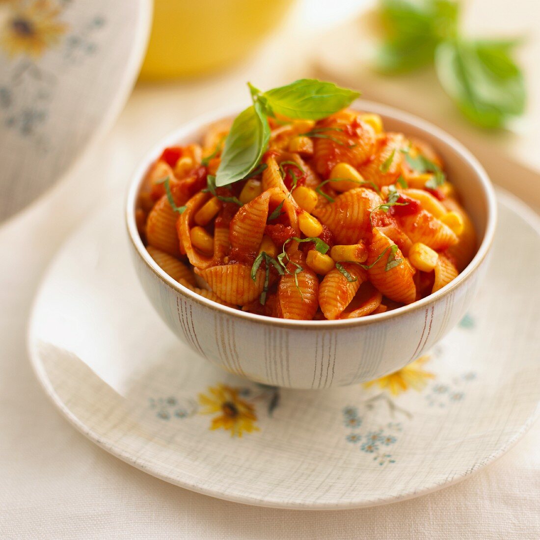 Pasta shells with tomato sauce, sweetcorn and basil