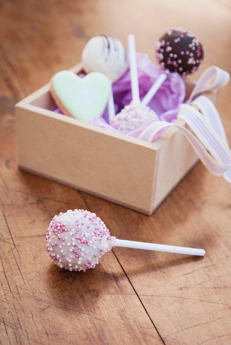 Assorted cake pops in a wooden box as a gift