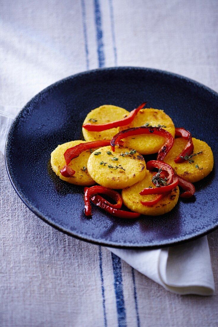 Polenta cakes with strips of red pepper