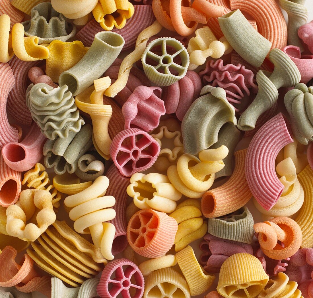 Pasta in assorted shapes and colours (filling the image)