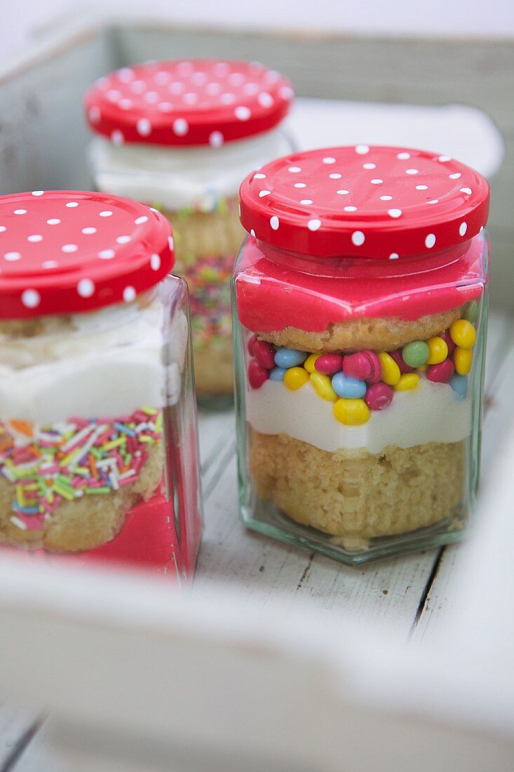 Cupcakes with frosting and sugar sprinkles in jars