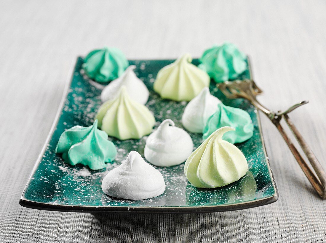 Colourful marshmallows bites on green plate