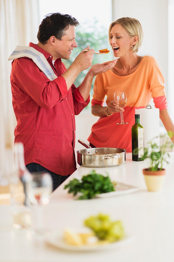 A couple cooking together in the kitchen