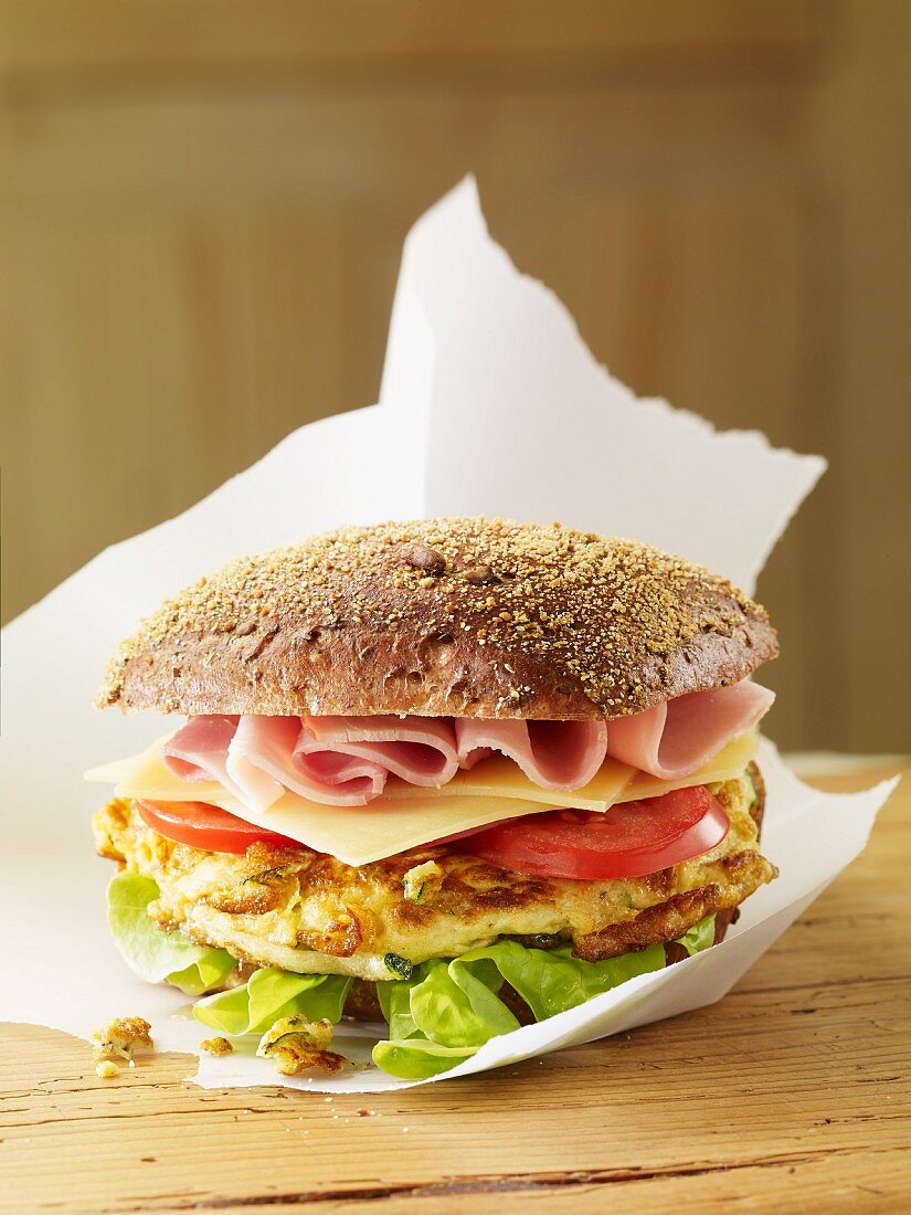 Burger with ham, cheese and tomatoes